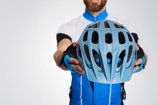 Person holding a Blue bike helmet